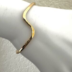 Gold tone wavy open cuff bracelet